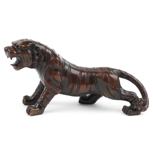 111 - A Japanese brown patinated bronze okimono figure of a tiger, 34cm in length.