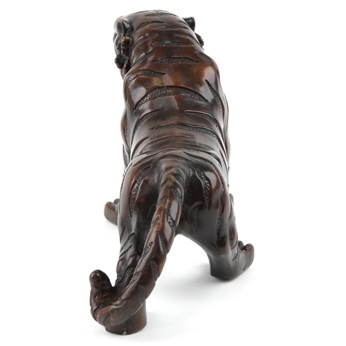 111 - A Japanese brown patinated bronze okimono figure of a tiger, 34cm in length.