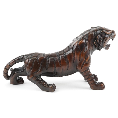 111 - A Japanese brown patinated bronze okimono figure of a tiger, 34cm in length.