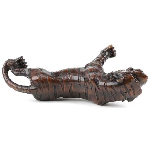 111 - A Japanese brown patinated bronze okimono figure of a tiger, 34cm in length.