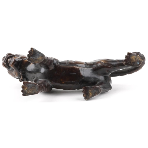 111 - A Japanese brown patinated bronze okimono figure of a tiger, 34cm in length.