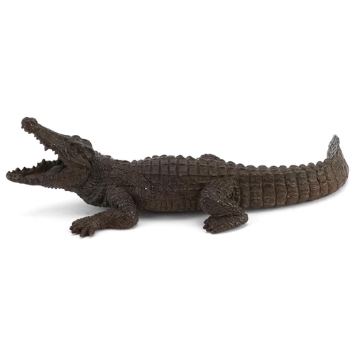 311 - A Japanese patinated bronze okimono figure of a crocodile, character marks to the base, 15cm in leng... 