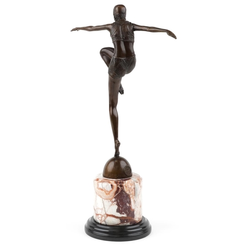 187 - A patinated bronze study of an Art Deco female dancer raised on a marble column base, 56cm high.