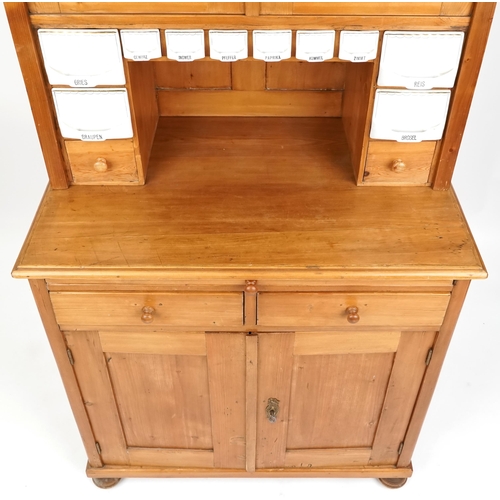 1134 - A 20th century pine narrow dresser, the top fitted with ceramic pull out drawers above two drawers a... 