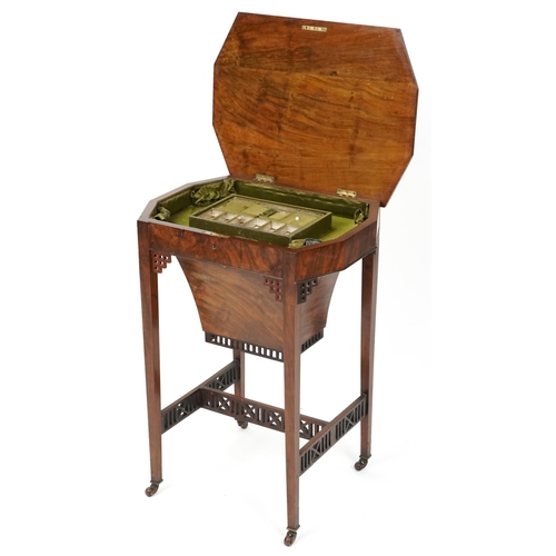 1045 - A mid Victorian burr walnut work table, the hinged lid above a well, raised on square tapering legs,... 