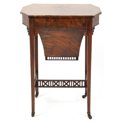 1045 - A mid Victorian burr walnut work table, the hinged lid above a well, raised on square tapering legs,... 