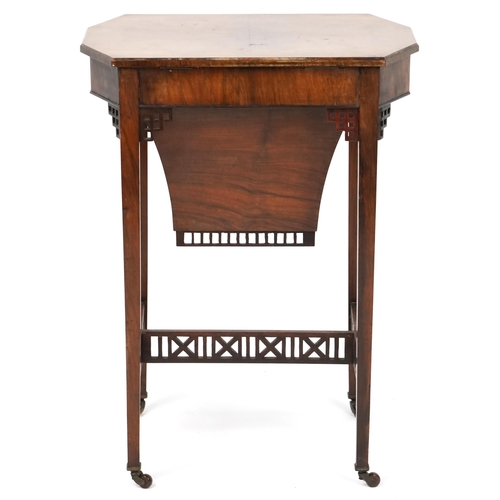 1045 - A mid Victorian burr walnut work table, the hinged lid above a well, raised on square tapering legs,... 