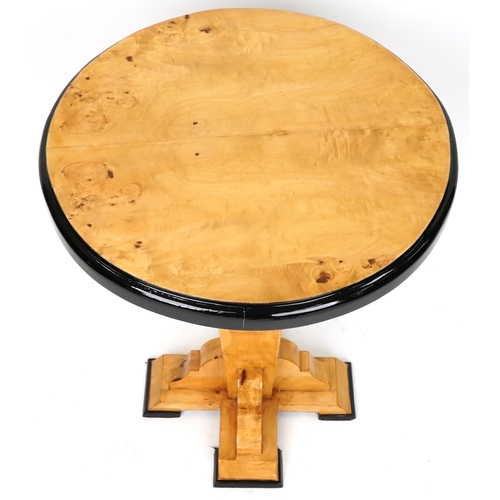 1053 - An Art Deco style satin maple veneered circular lamp table with ebonised decoration, 73cm high x 59c... 