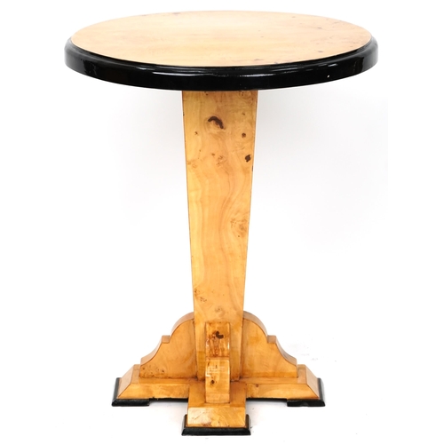 1053 - An Art Deco style satin maple veneered circular lamp table with ebonised decoration, 73cm high x 59c... 