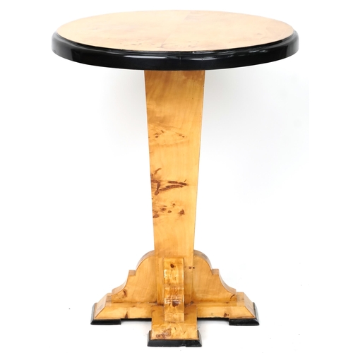 1052 - An Art Deco style satin maple veneered circular lamp table with ebonised decoration, 73cm high x 59c... 