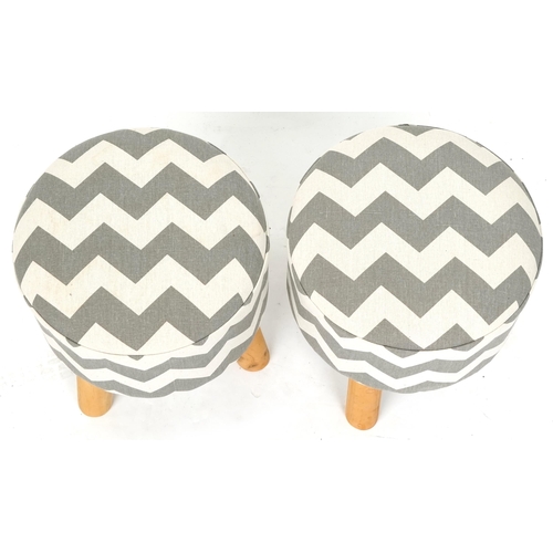 1091 - A pair of modern circular footstools upholstered in a striped fabric, on tripod legs, 34cm high x 31... 