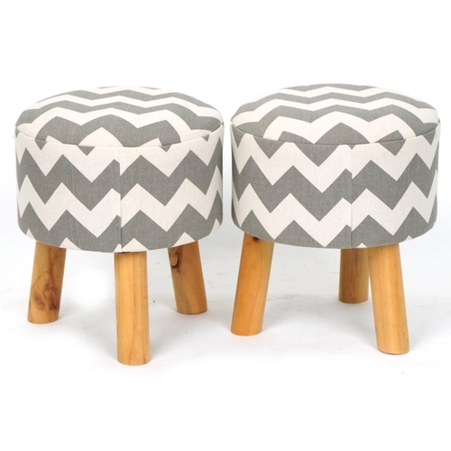 1091 - A pair of modern circular footstools upholstered in a striped fabric, on tripod legs, 34cm high x 31... 