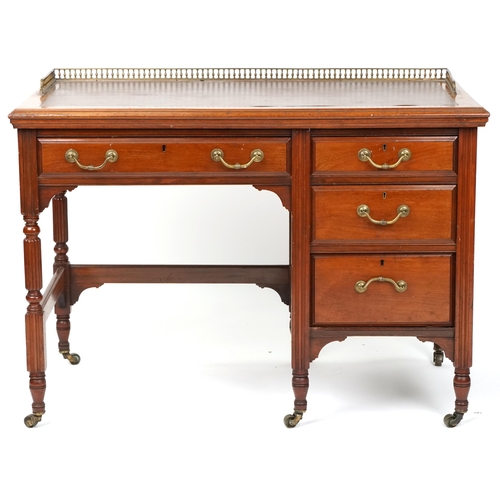 1016 - An Edwardian mahogany single pedestal desk fitted with a three quarter brass gallery back above an a... 