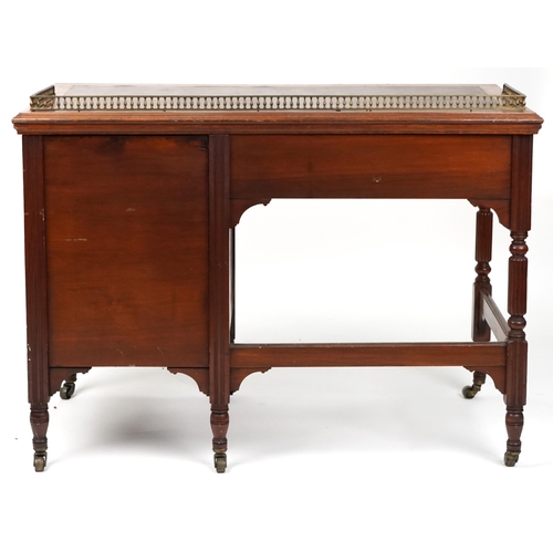 1016 - An Edwardian mahogany single pedestal desk fitted with a three quarter brass gallery back above an a... 