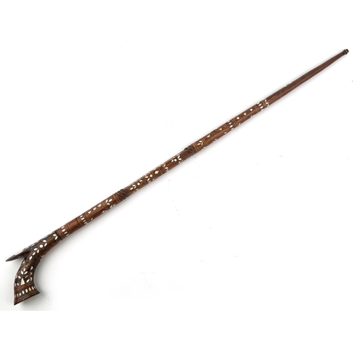 1405 - An Islamic wooden walking stick with mother-of-pearl inlaid decoration, 97cm in length.