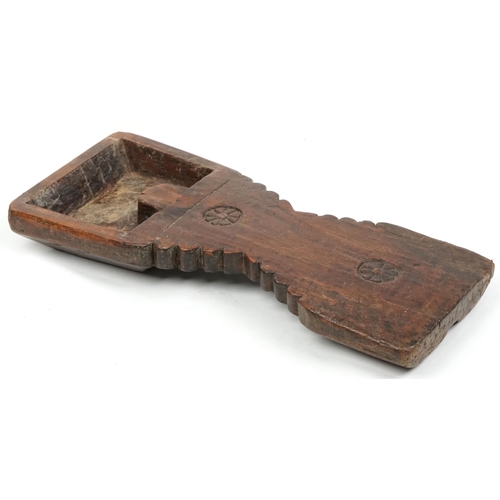 333A - A late 19th/early 20th century carved hardwood food board, probably African, 73cm in length.