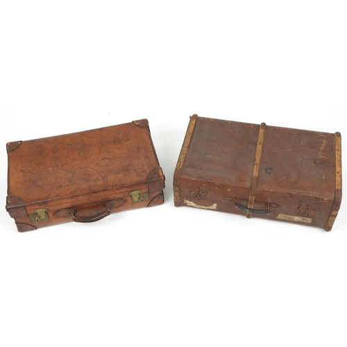 1100 - An early 20th century brown leather suitcase, 67cm wide, together with a similar brown canvas case, ... 