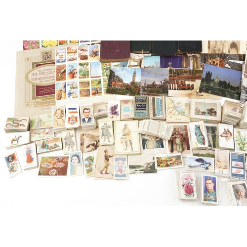 2254 - A mixed group of ephemera to include various cigarette card sets, photographic holiday souvenir phot... 