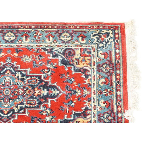 1031 - A Turkomen rug, late 20th century, the red field with a central stepped medallion, 143cm x 90cm, tog... 