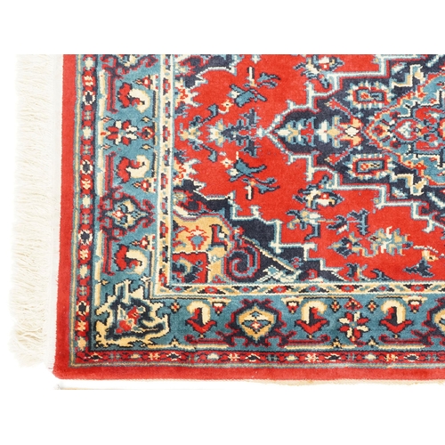 1031 - A Turkomen rug, late 20th century, the red field with a central stepped medallion, 143cm x 90cm, tog... 