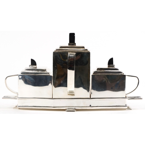 1484 - An Art Deco style plated teapot together with a sugar pot and milk jug on stand, 40cm wide.