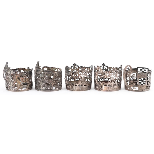 482 - Five Edwardian and later pierced silver coffee can holders, each 4.5cm in diameter, total 121.0g