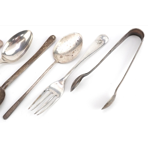 469 - Silver objects including two Arts & Crafts silver spoons and sugar tongs, the largest 13cm in length... 