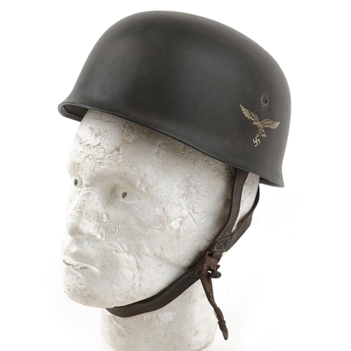 2592 - German military World War II Fallschirmjäger tin helmet with liner and chin strap.