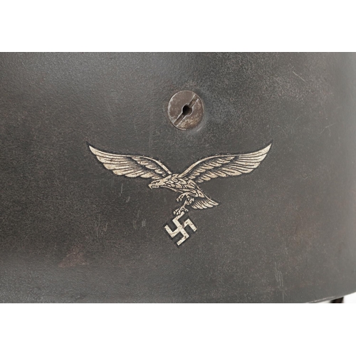 2592 - German military World War II Fallschirmjäger tin helmet with liner and chin strap.