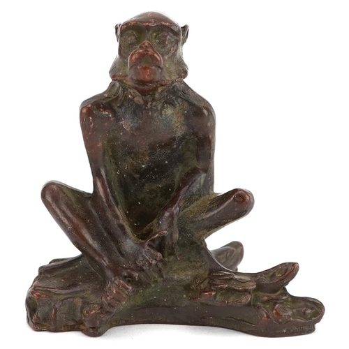 115 - A Japanese patinated bronze okimono of a seated monkey, character marks to the base, 6cm high.