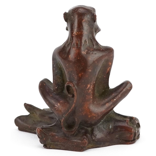 115 - A Japanese patinated bronze okimono of a seated monkey, character marks to the base, 6cm high.