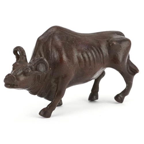 117 - A Japanese patinated bronze study of a wildebeest, 7.5cm in length.