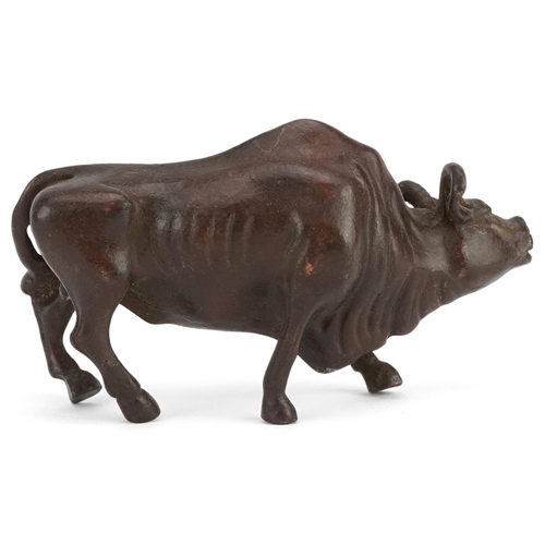 117 - A Japanese patinated bronze study of a wildebeest, 7.5cm in length.