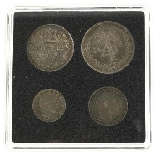 2063 - An Edward VII 1902 set of Maundy money comprising four coins housed in a black plastic case.