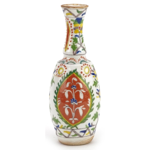 120 - A Turkish Ottoman Kütahya vase hand painted with stylized flowers, 20cm high.