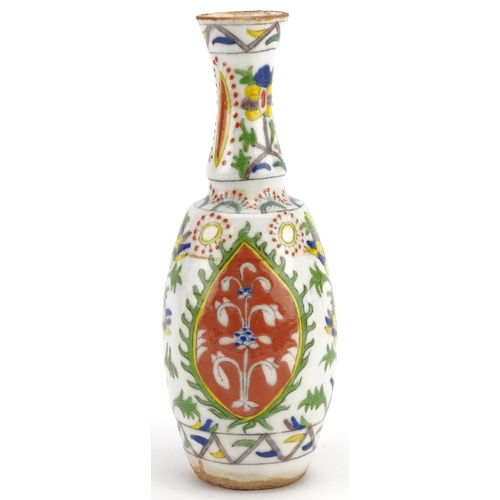 120 - A Turkish Ottoman Kütahya vase hand painted with stylized flowers, 20cm high.