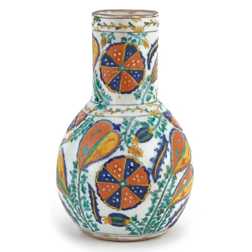 191 - A Turkish Ottoman Kütahya vase hand painted with stylized flowers and foliage, 22cm high.