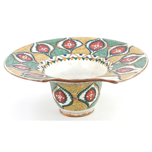 119 - A Turkish Ottoman Kütahya barber's bowl hand painted with stylized flowers and foliage, 31.5cm wide.