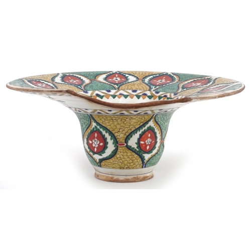 119 - A Turkish Ottoman Kütahya barber's bowl hand painted with stylized flowers and foliage, 31.5cm wide.