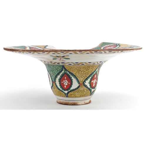 119 - A Turkish Ottoman Kütahya barber's bowl hand painted with stylized flowers and foliage, 31.5cm wide.