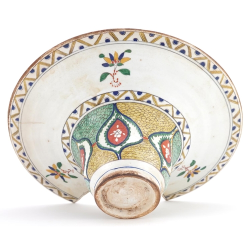 119 - A Turkish Ottoman Kütahya barber's bowl hand painted with stylized flowers and foliage, 31.5cm wide.