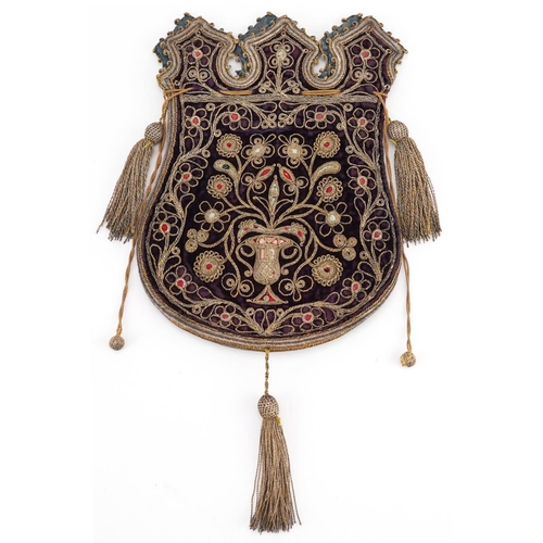 122 - A Turkish Ottoman textile money bag with tassels, embroidered with stylized motifs, 30cm wide.