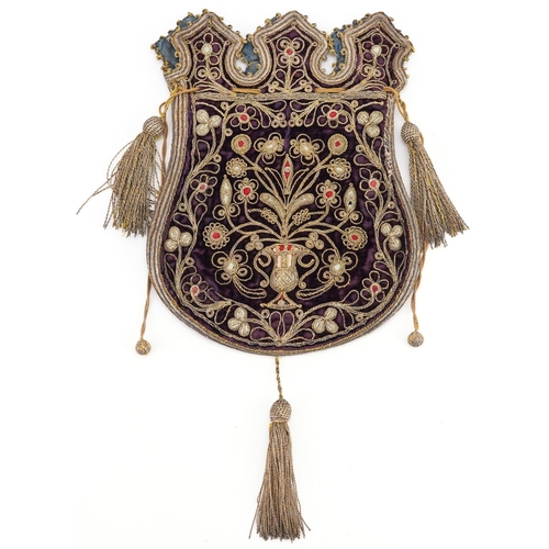 122 - A Turkish Ottoman textile money bag with tassels, embroidered with stylized motifs, 30cm wide.