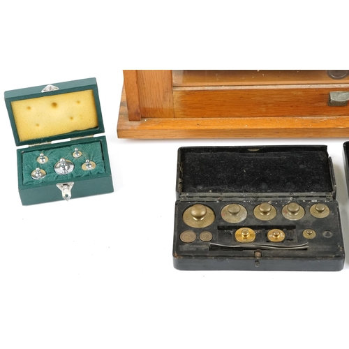 1504 - A set of mid-20th Century scientific balance scales by Philip Harris Ltd, Birmingham, within a glaze... 