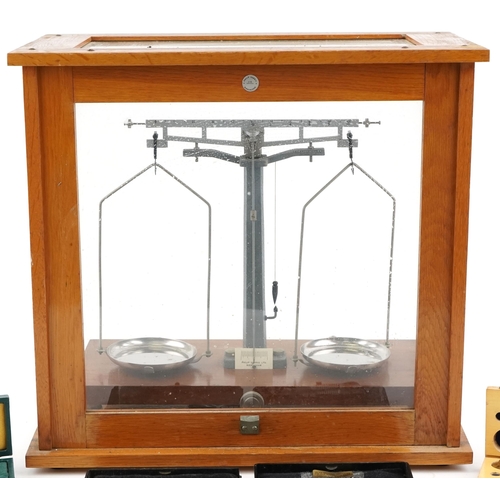 1504 - A set of mid-20th Century scientific balance scales by Philip Harris Ltd, Birmingham, within a glaze... 