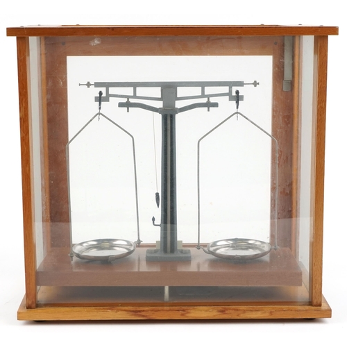 1504 - A set of mid-20th Century scientific balance scales by Philip Harris Ltd, Birmingham, within a glaze... 