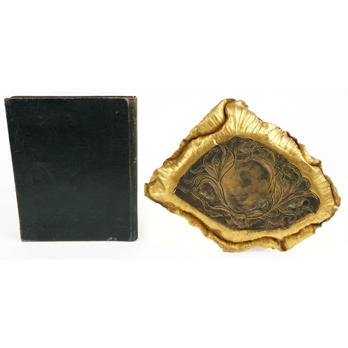 128 - A Victorian gilt metal mounted desk blotter with engraved left scrolls, W-24cm together with a Victo... 