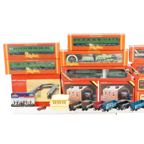 1325 - A Hornby OO gauge model railway locomotive and coaches with trackside buildings and accessories, som... 