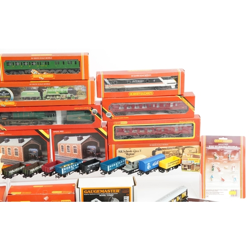 1325 - A Hornby OO gauge model railway locomotive and coaches with trackside buildings and accessories, som... 