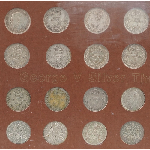 2104 - A collection of George V silver threepence pieces housed in a plastic display case.